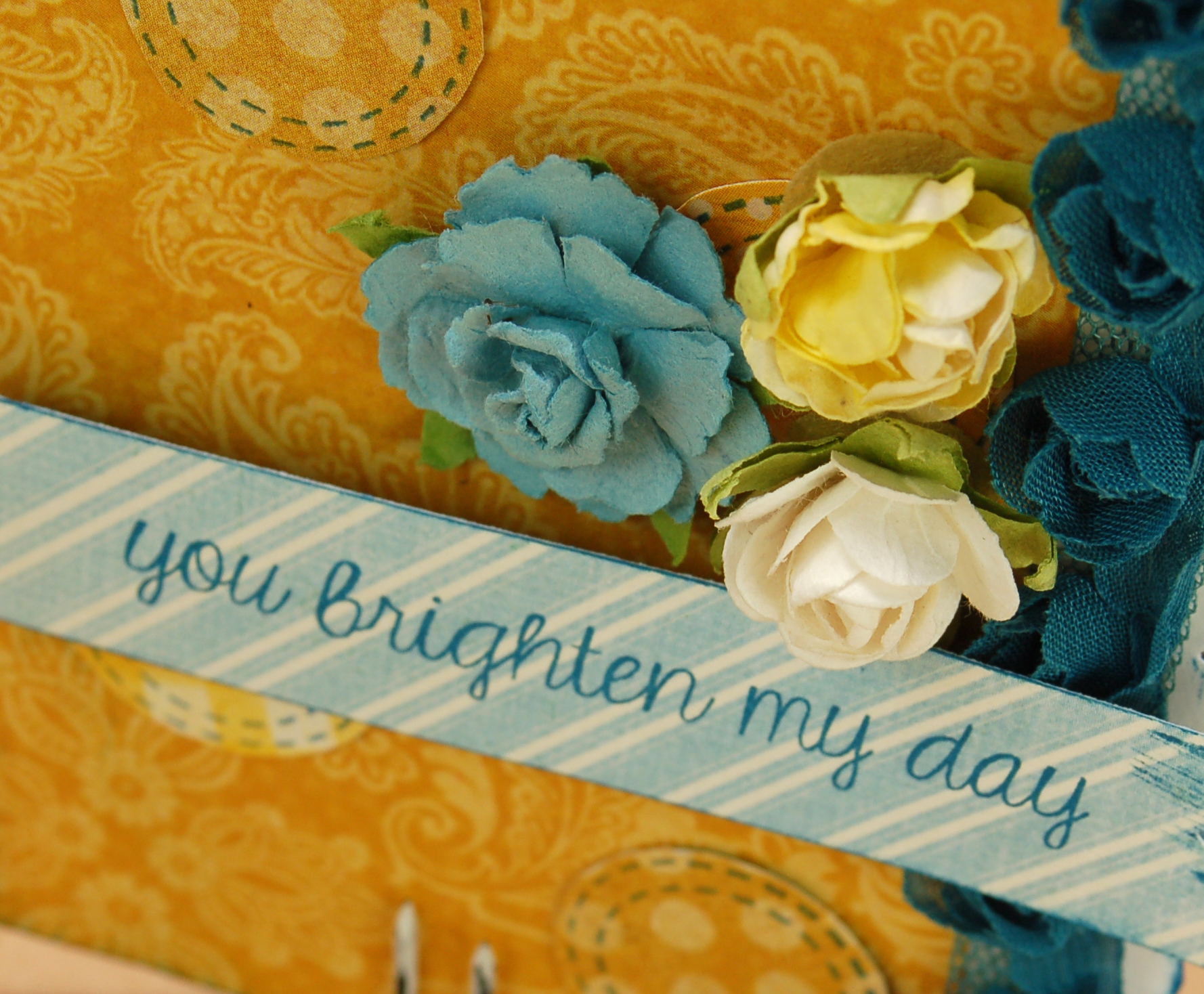 close up of yellow and blue card with stamped message that says you brighten my day